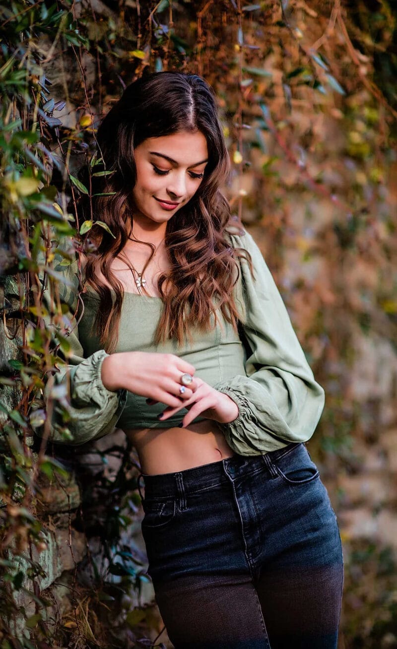 High School Senior Portrait: Senior Leaning on Ivy Wall