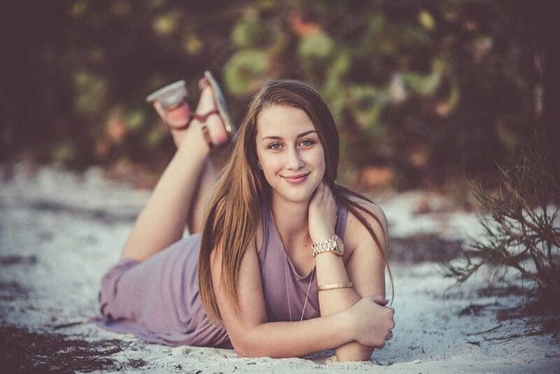 High School Senior: Lying in the Park on the Snow